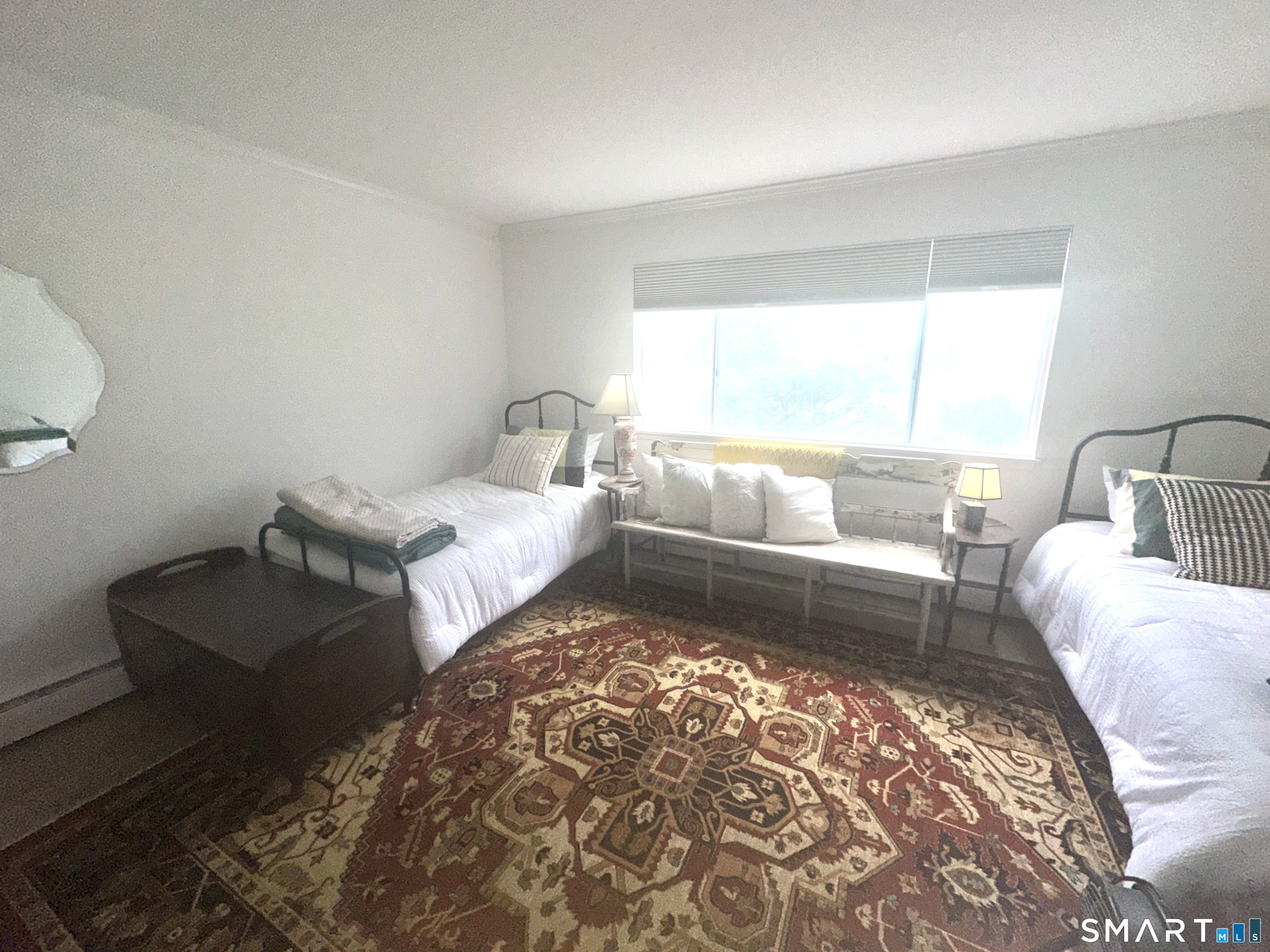 126 Sherman Hill Road, Unit C14 Woodbury, CT 06798 - Photo 22 of 27 a living room with a couch and a rug