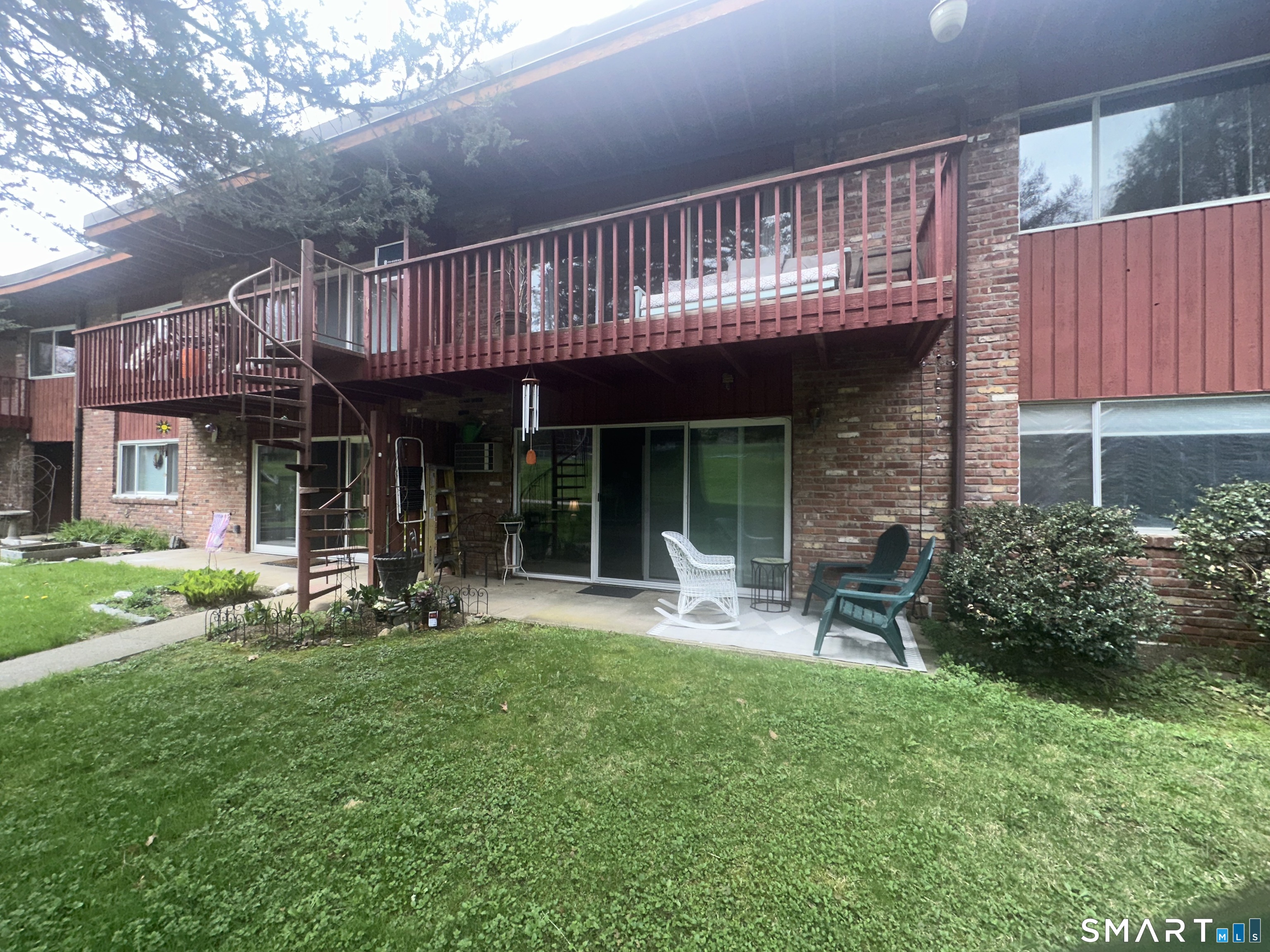 126 Sherman Hill Road, Unit C14 Woodbury, CT 06798 - Photo 24 of 27 a view of a house with a yard and sitting area