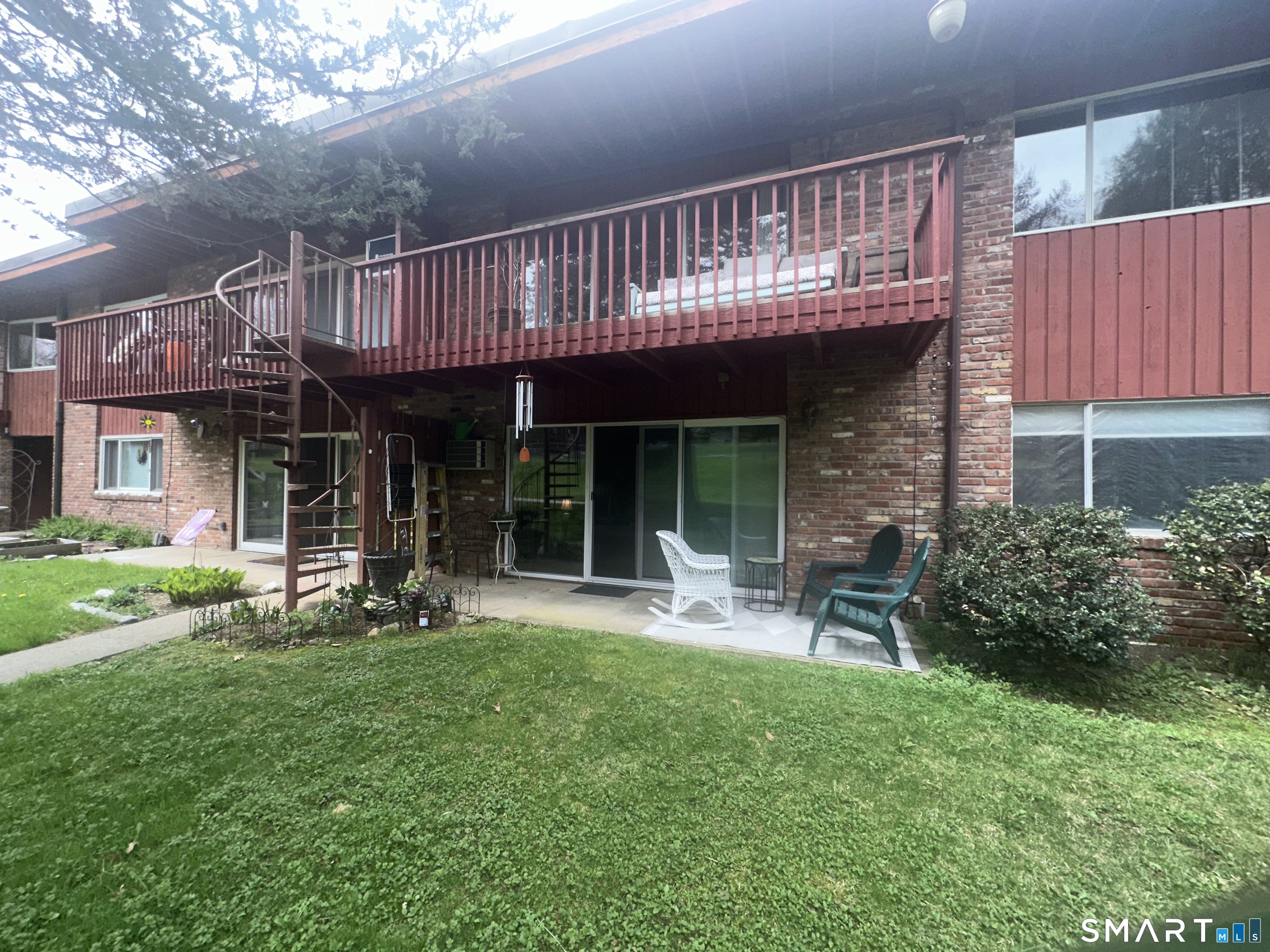 126 Sherman Hill Road, Unit C14 Woodbury, CT 06798 - Photo 26 of 27 a view of a house with a yard and sitting area