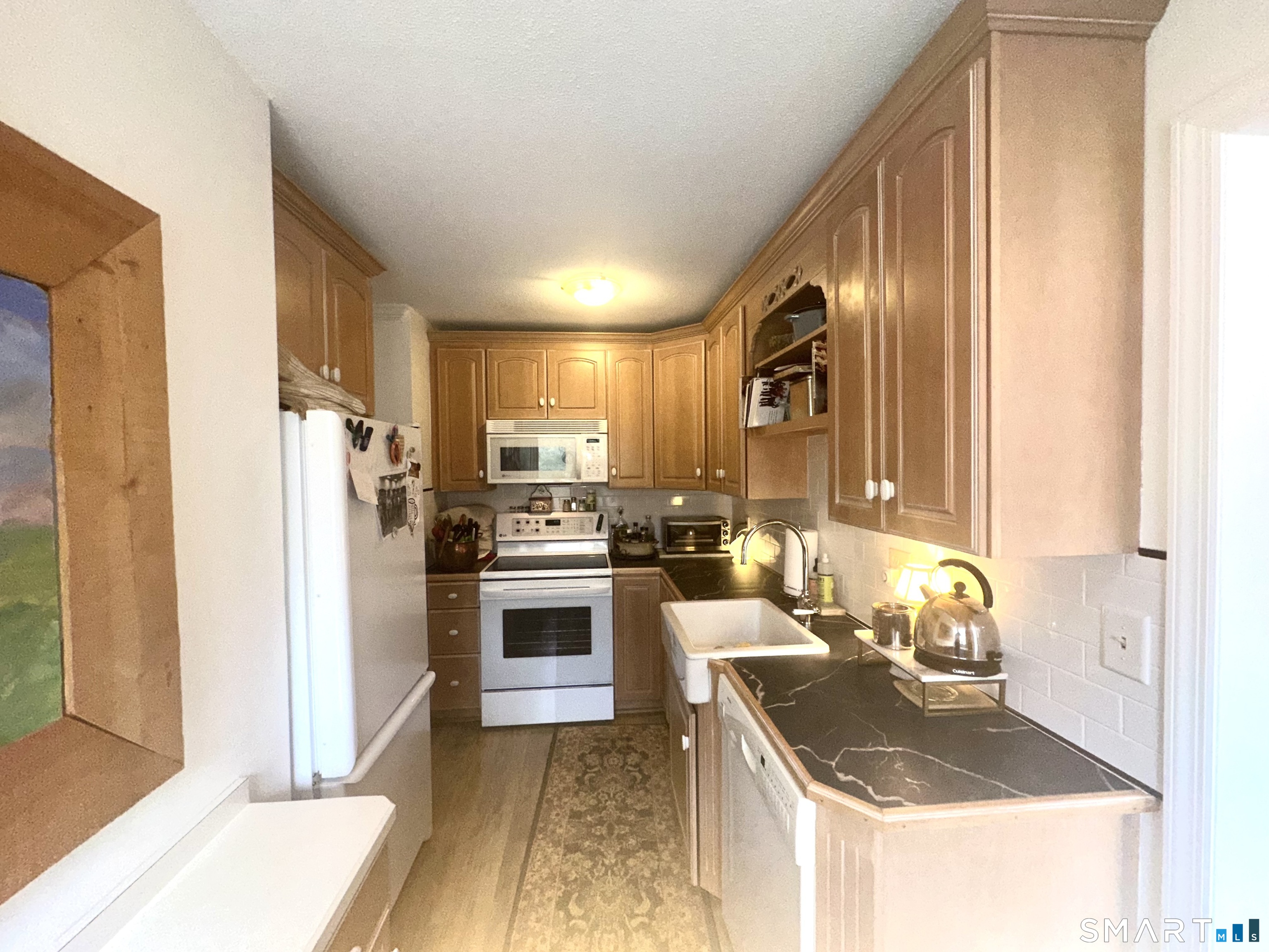 126 Sherman Hill Road, Unit C14 Woodbury, CT 06798 - Photo 8 of 27 a kitchen with granite countertop stainless steel appliances a stove sink and refrigerator
