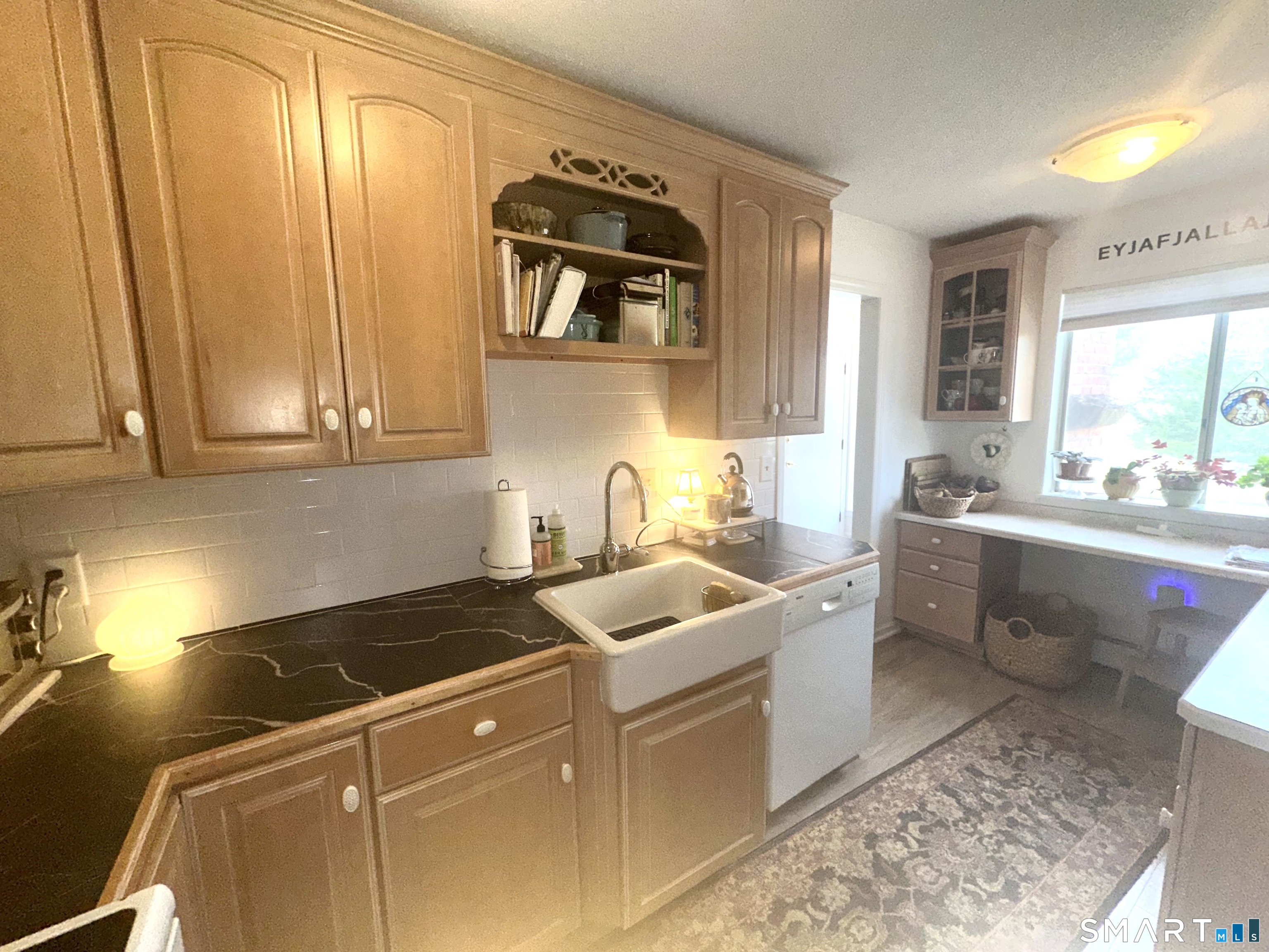 126 Sherman Hill Road, Unit C14 Woodbury, CT 06798 - Photo 9 of 27 a kitchen with a sink and cabinets