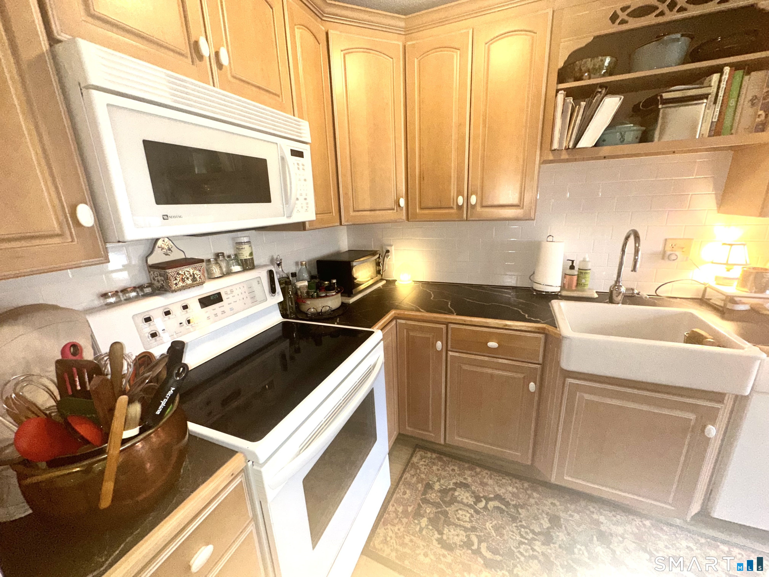 126 Sherman Hill Road, Unit C14 Woodbury, CT 06798 - Photo 10 of 27 a kitchen with stainless steel appliances granite countertop a sink stove and cabinets