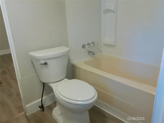 a view of a closet with wooden walls