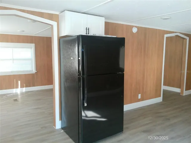 a view of a refrigerator in kitchen and wooden floor