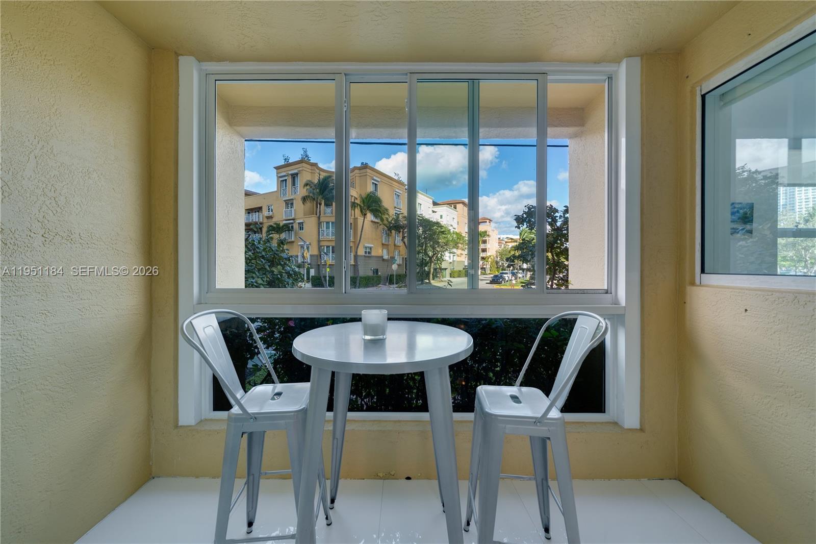 90 Alton Road, Unit TH1 Miami Beach, FL 33139 - Photo 11 of 48 a view of a dining room with furniture window and outside view