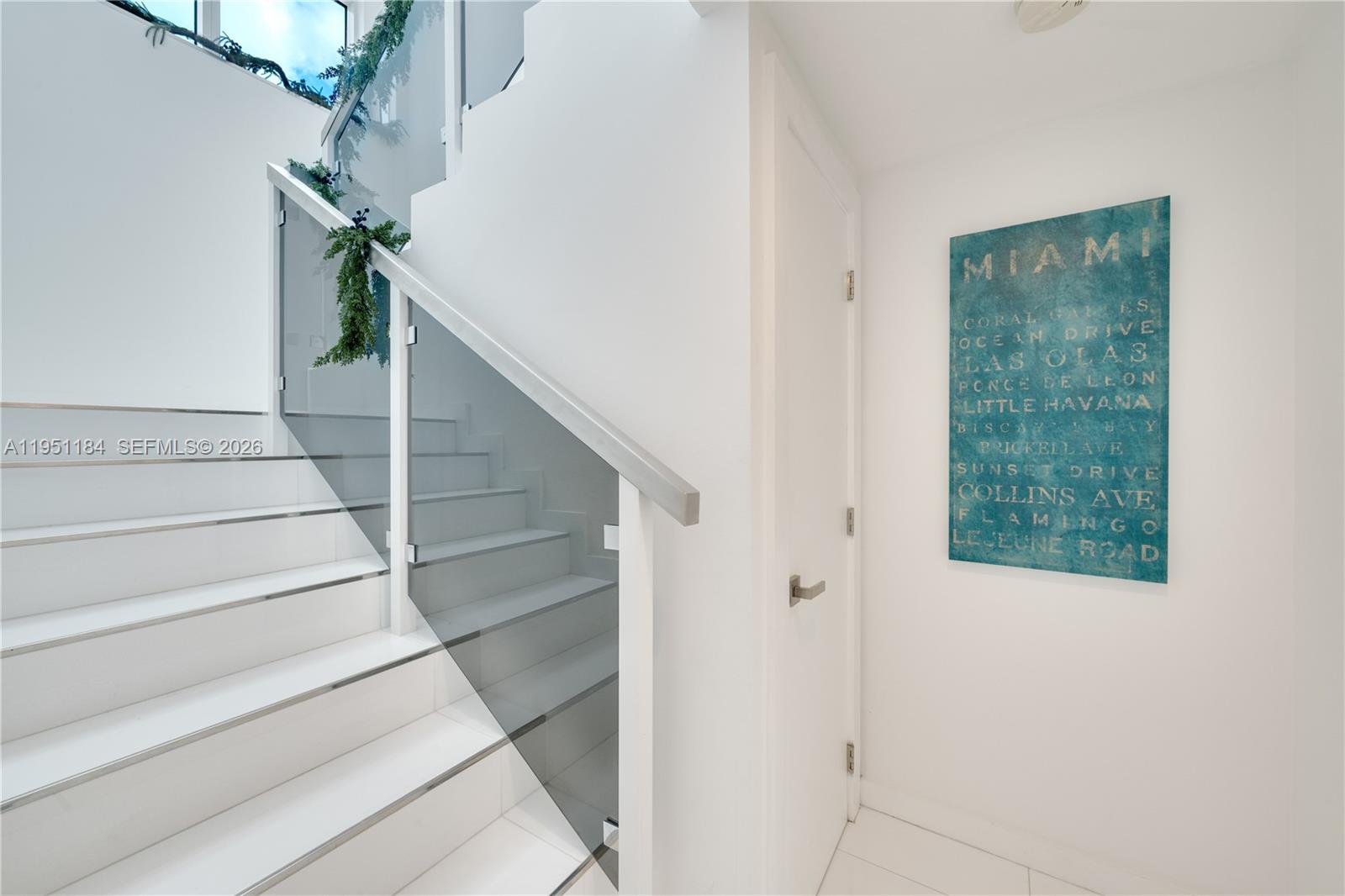 90 Alton Road, Unit TH1 Miami Beach, FL 33139 - Photo 12 of 48 a view of staircase with white walls and a window
