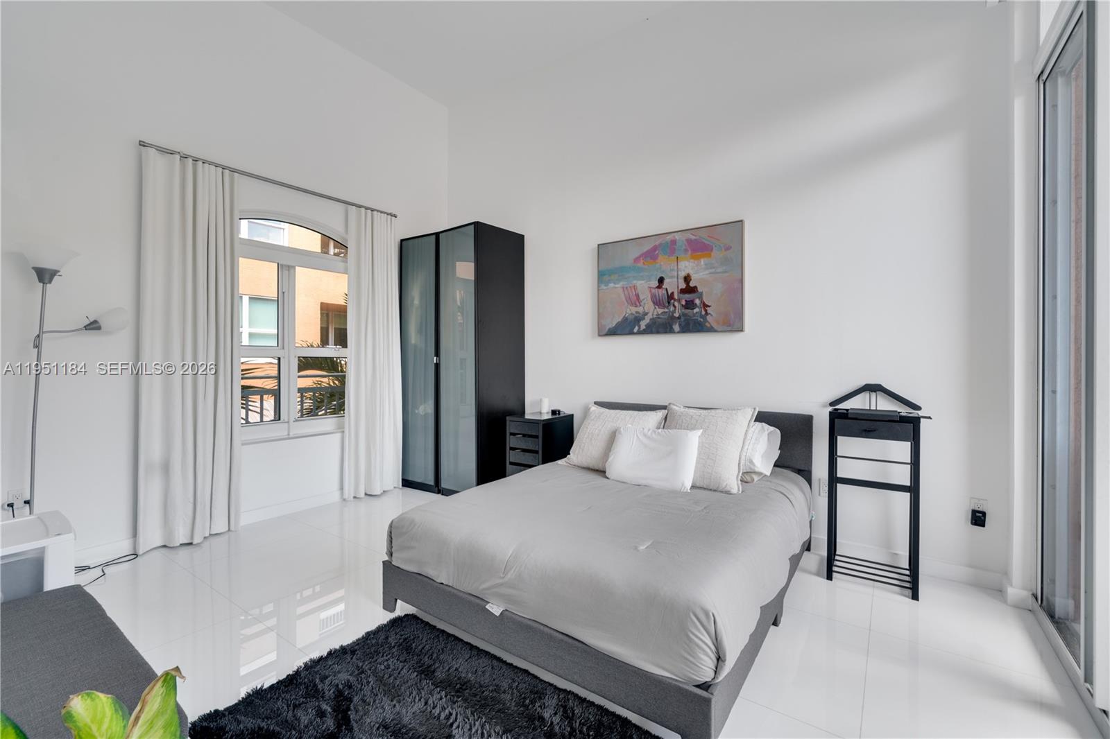 90 Alton Road, Unit TH1 Miami Beach, FL 33139 - Photo 13 of 48 a bedroom with a bed and a painting on the wall