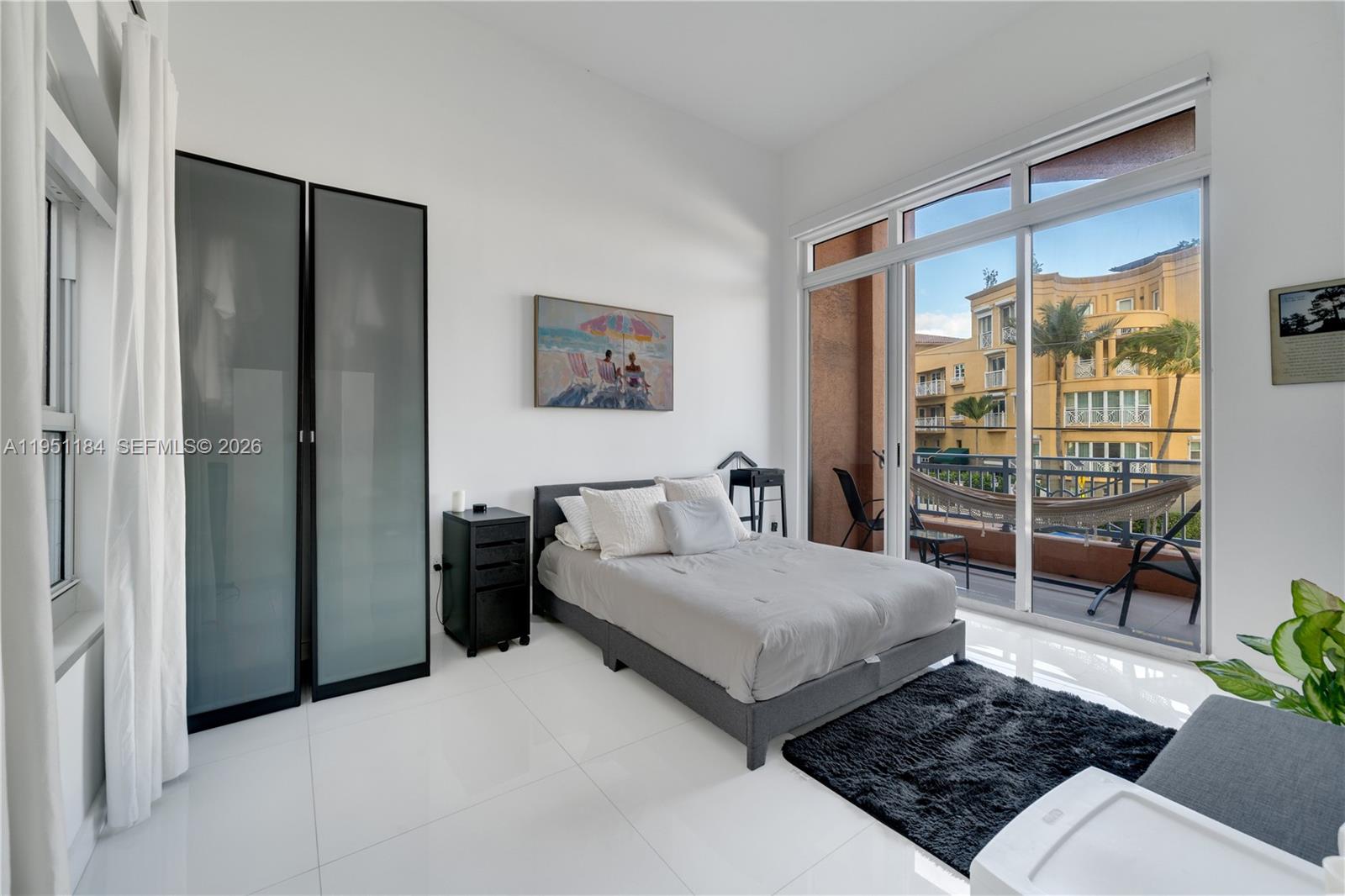 90 Alton Road, Unit TH1 Miami Beach, FL 33139 - Photo 14 of 48 a bedroom with a bed and a table