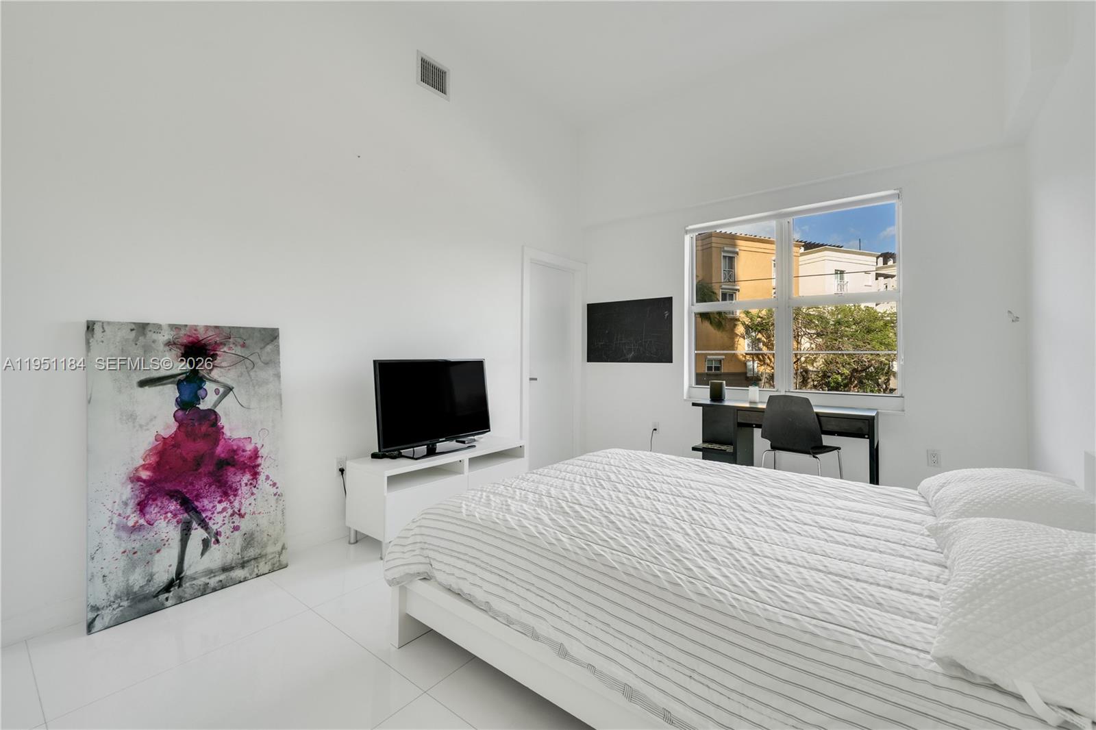90 Alton Road, Unit TH1 Miami Beach, FL 33139 - Photo 20 of 48 a bedroom with a bed and a flat screen tv