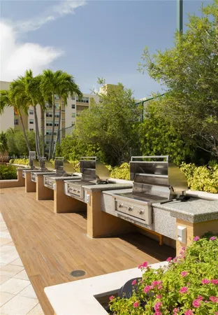 a room with lots of tables a large window and chairs