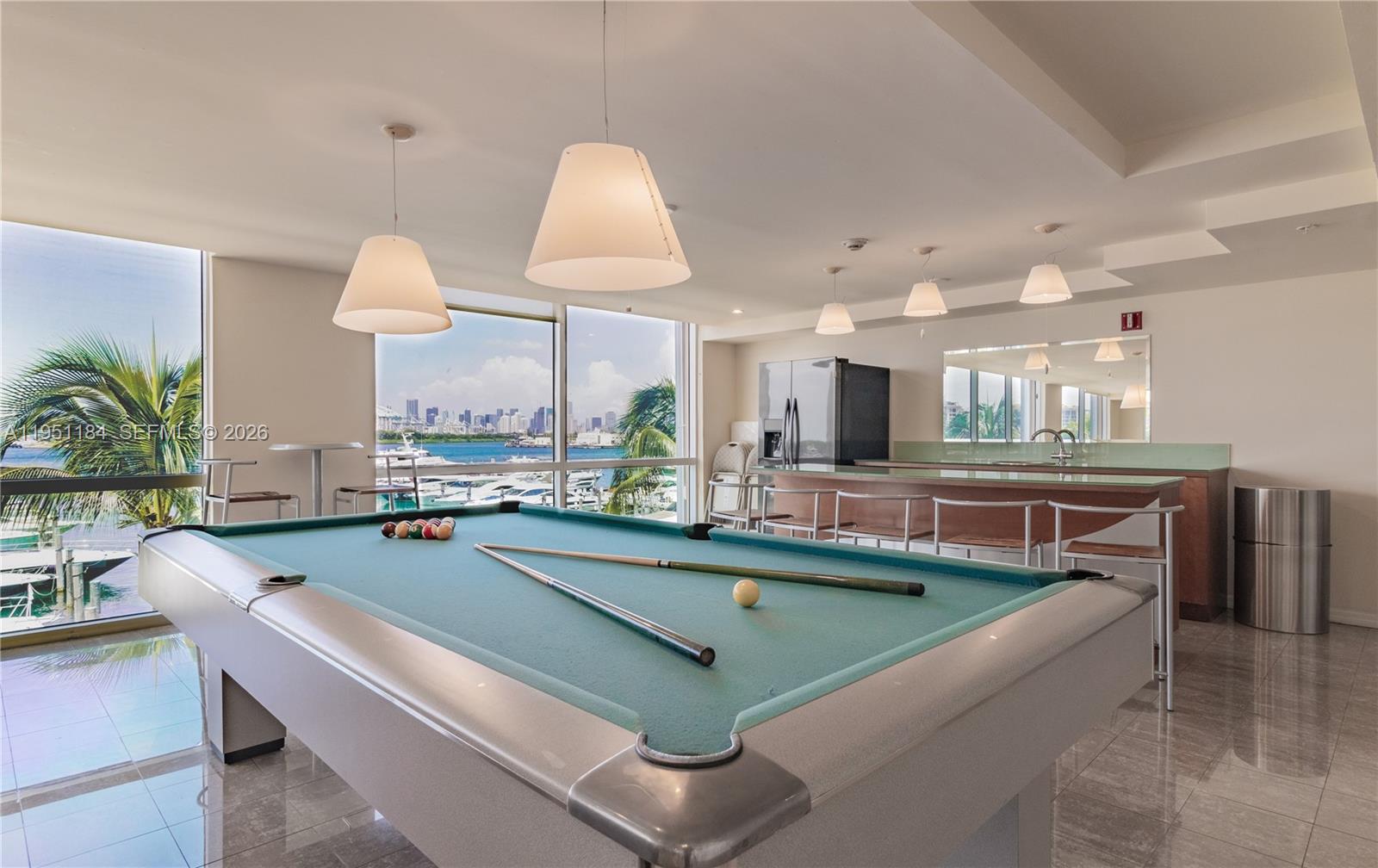 90 Alton Road, Unit TH1 Miami Beach, FL 33139 - Photo 35 of 48 a kitchen with kitchen island stainless steel appliances a sink and a living room view