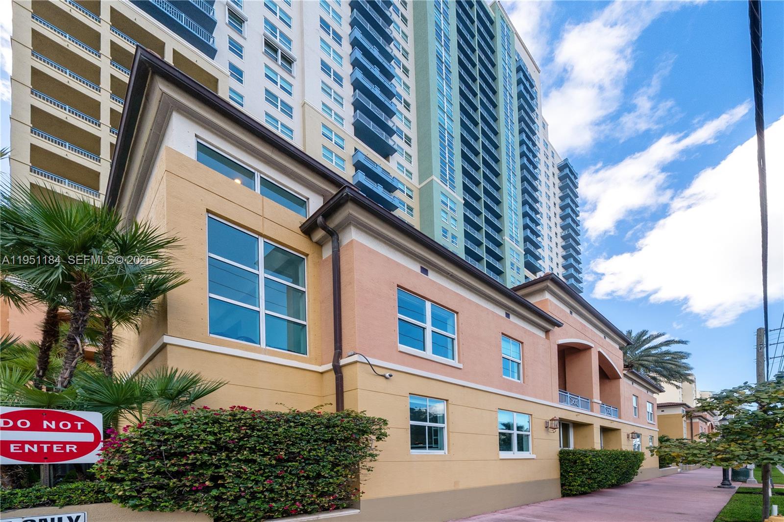 90 Alton Road, Unit TH1 Miami Beach, FL 33139 - Photo 4 of 48 a front view of a multi story residential apartment building with yard and sign board