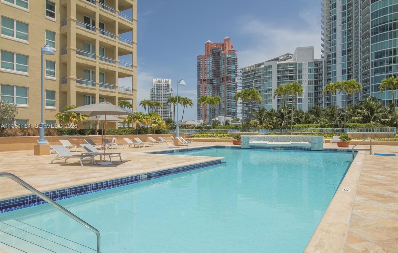 90 Alton Road, Unit TH1 Miami Beach, FL 33139 - Photo 43 of 48 a view of a swimming pool with outdoor seating