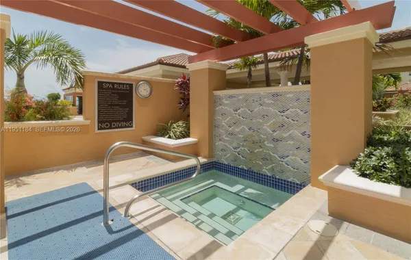 a view of a tennis court with swimming pool and a buildings