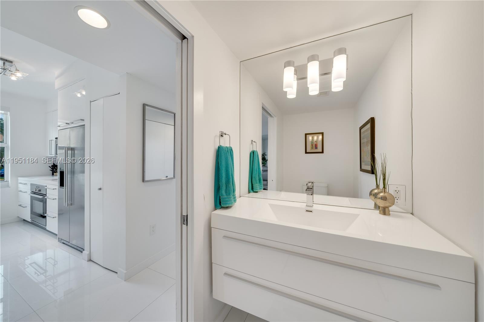 90 Alton Road, Unit TH1 Miami Beach, FL 33139 - Photo 9 of 48 a bathroom with a sink and a mirror