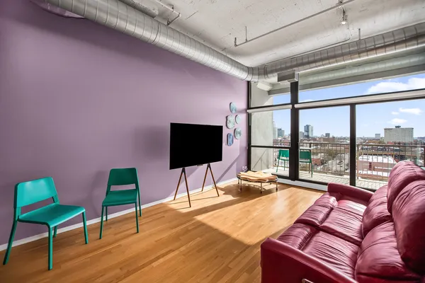 a blue couch sitting in a living room next to a large window