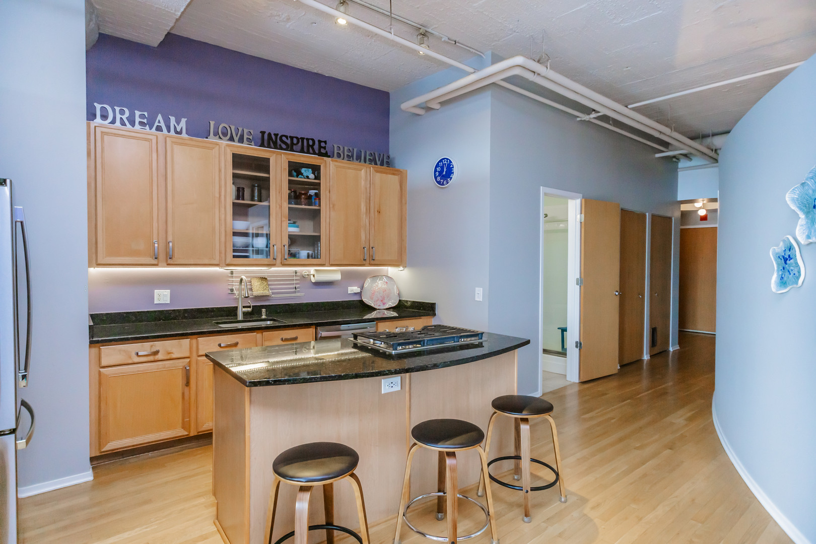 1530 South State Street, Unit 917 Chicago, IL 60605 - Photo 7 of 14 a kitchen with stainless steel appliances granite countertop a stove a sink and a refrigerator