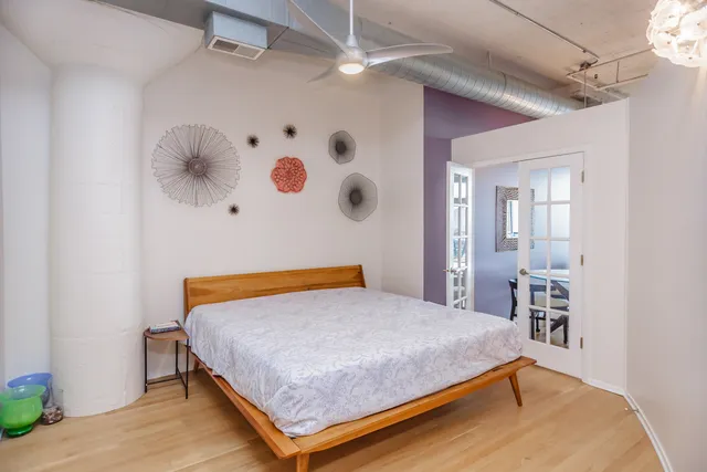 a bedroom with a bed and a chair