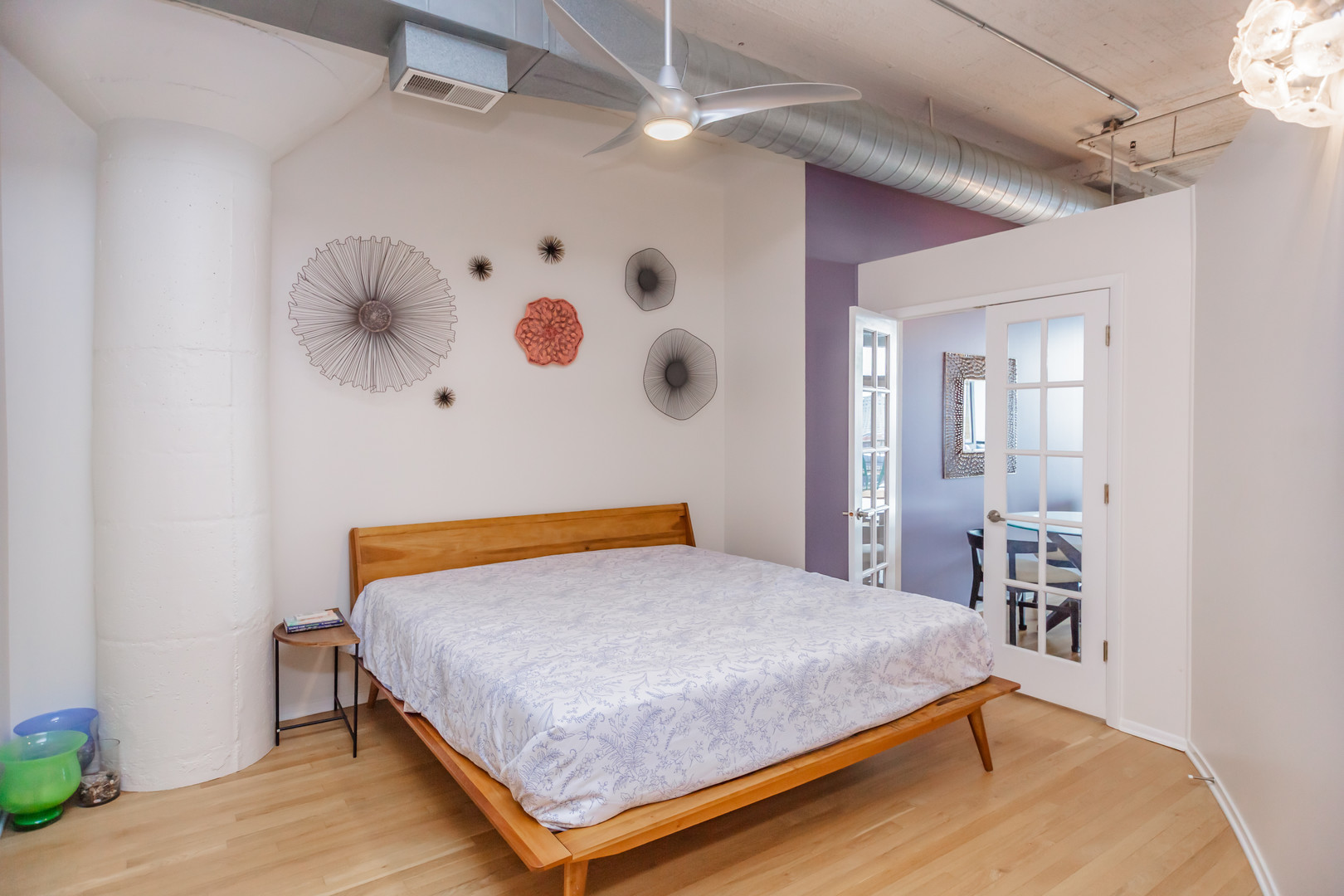 1530 South State Street, Unit 917 Chicago, IL 60605 - Photo 8 of 14 a bedroom with a bed and a chandelier