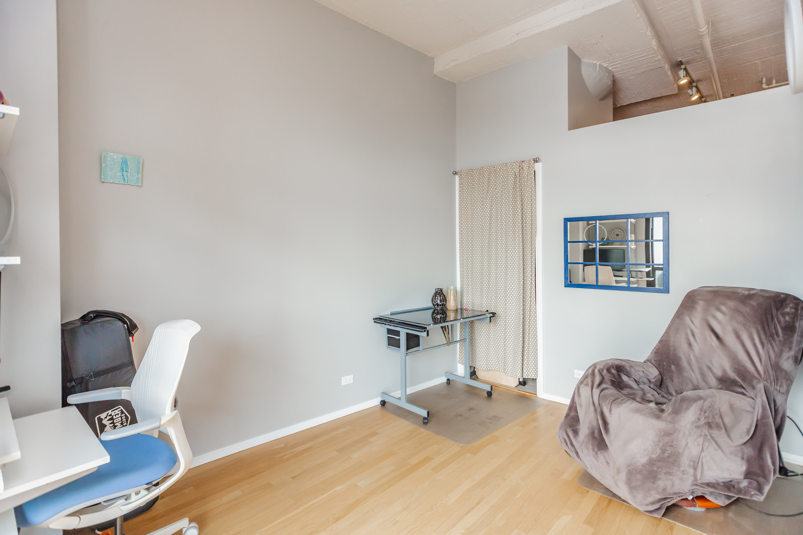 1530 South State Street, Unit 917 Chicago, IL 60605 - Photo 9 of 14 a bedroom with a bed and a chair