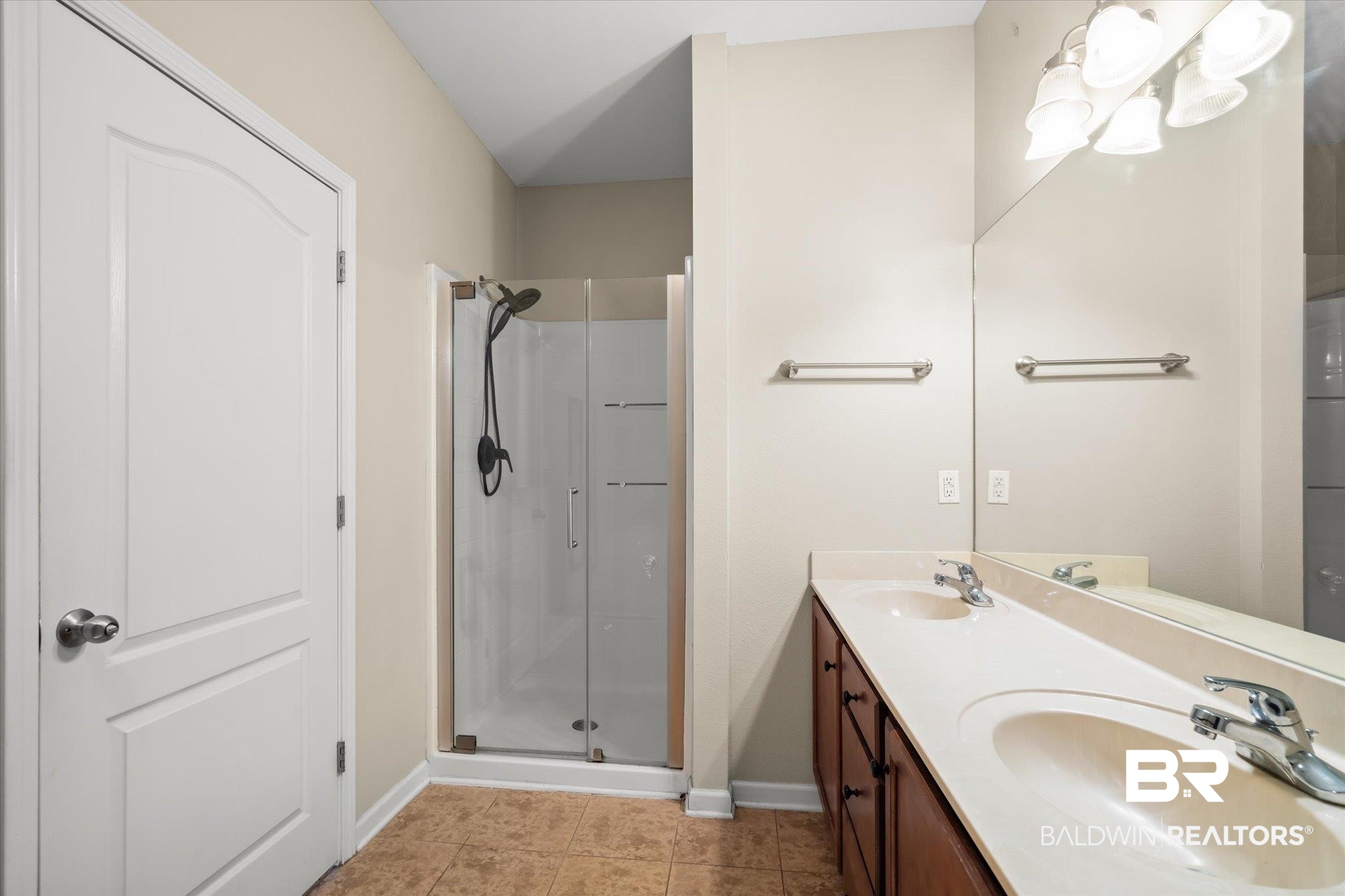 10251 Fionn Loop Daphne, AL 36526 - Photo 14 of 28 Bathroom with tile patterned floors, vanity, and a shower with shower door