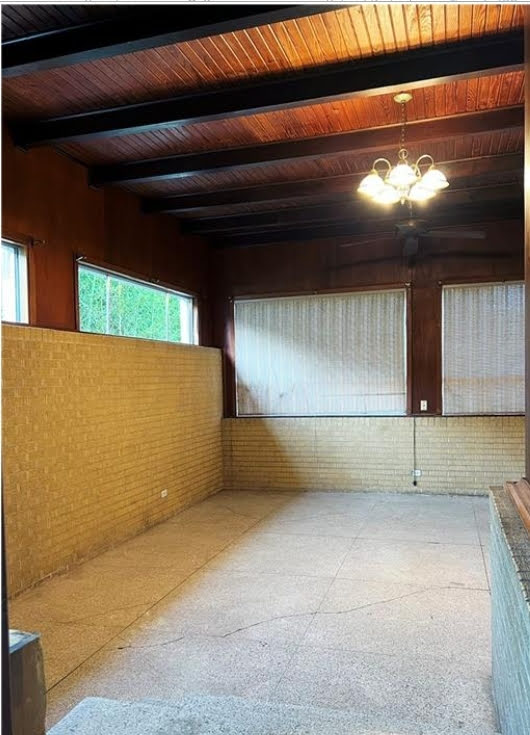 809 North 8th Street Temple, TX 76501 - Photo 15 of 20 A versatile indoor-outdoor space features a rich wood-paneled ceiling and durable brick wainscoting.