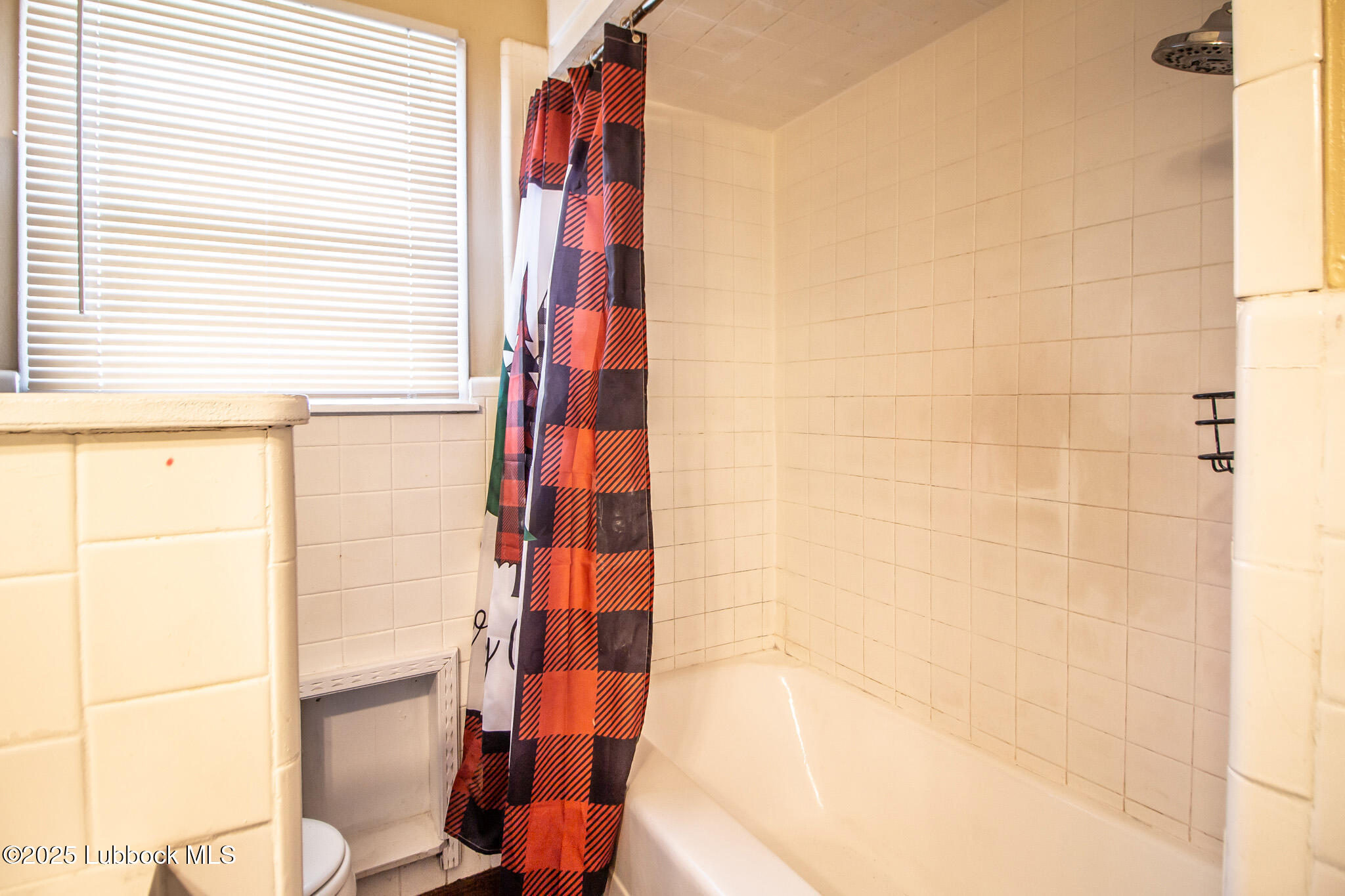 2414 38th Street Lubbock, TX 79412 - Photo 14 of 20 a bathroom with a shower and a toilet