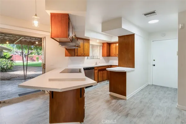a kitchen with a sink cabinets and wooden floor