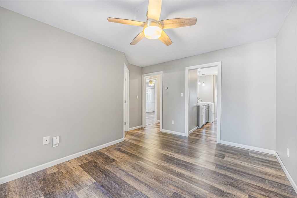 82 Mitchell Drive, Unit 82 Chicopee, MA 01022 - Photo 11 of 31 wooden floor in an empty room with a window