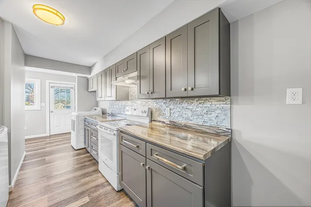 a kitchen with a sink stove and cabinets