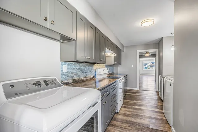 a kitchen with a sink stove and cabinets