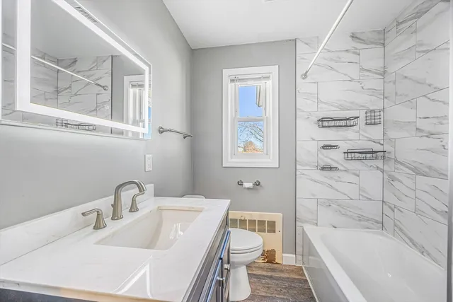 a bathroom with a sink toilet and shower