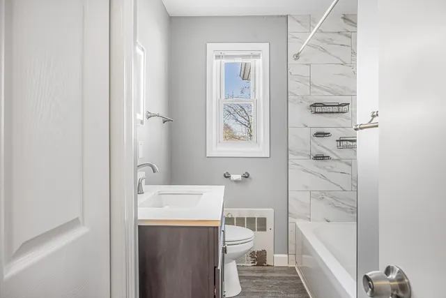 a bathroom with a sink a toilet and shower