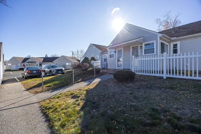 a view of a house with backyard and porch