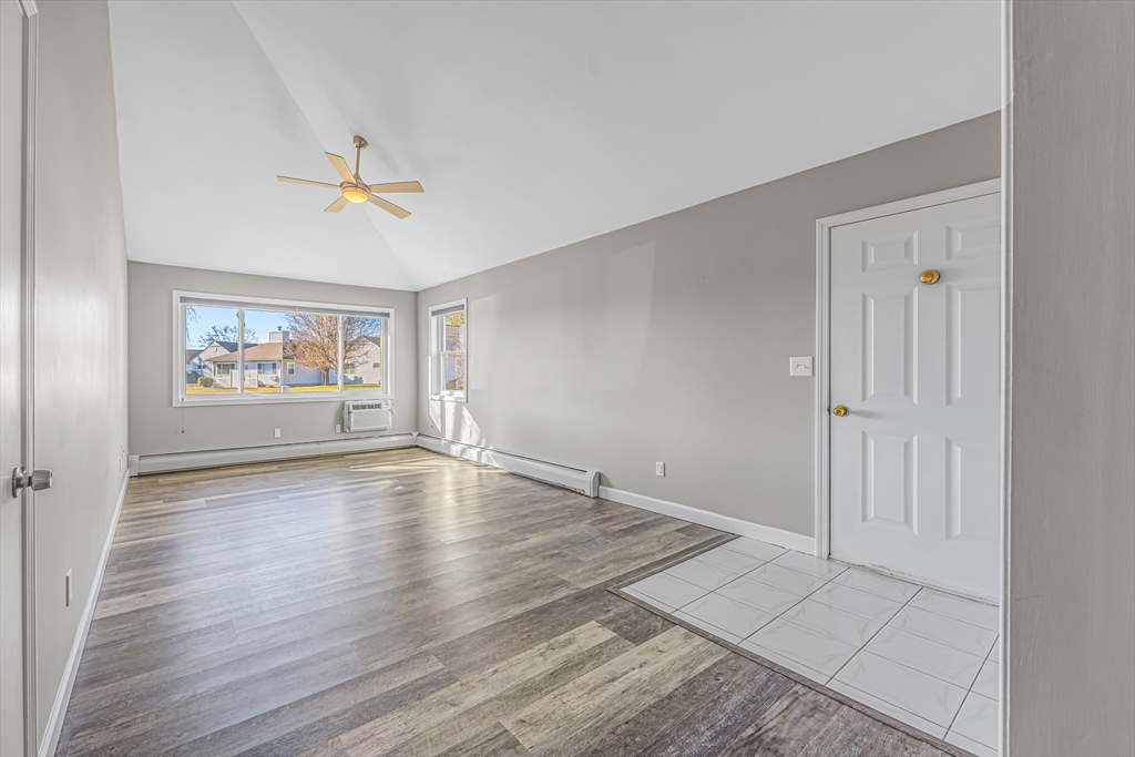 82 Mitchell Drive, Unit 82 Chicopee, MA 01022 - Photo 6 of 31 wooden floor in an empty room with a window