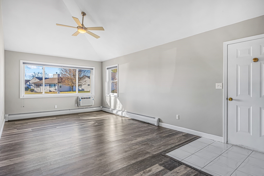 82 Mitchell Drive, Unit 82 Chicopee, MA 01022 - Photo 7 of 31 wooden floor in an empty room with a window