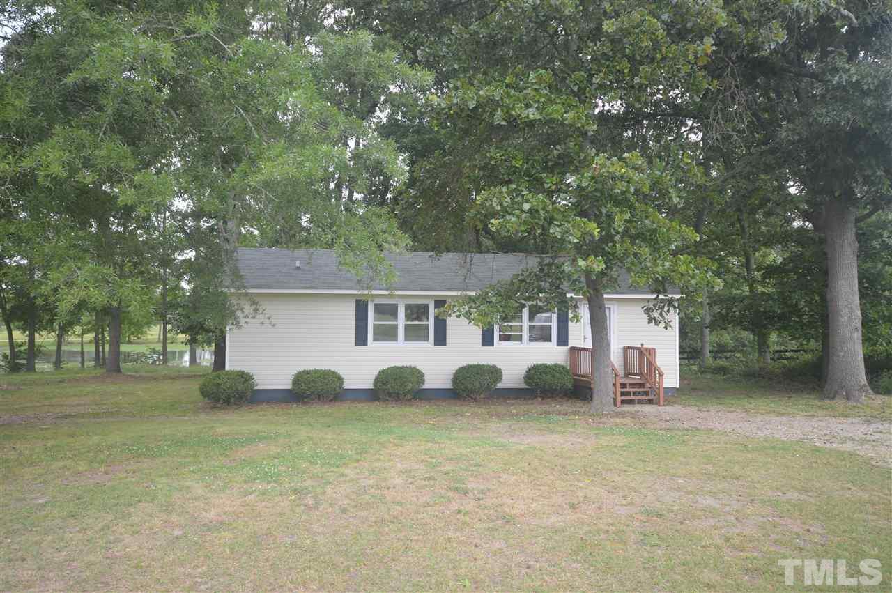 329 Clinton Carlyle Road Zebulon, NC 27597 - Photo 1 of 24 a house view with a garden space