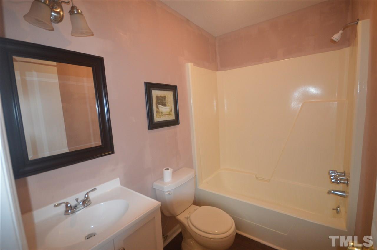 329 Clinton Carlyle Road Zebulon, NC 27597 - Photo 11 of 24 a bathroom with a sink a toilet and shower