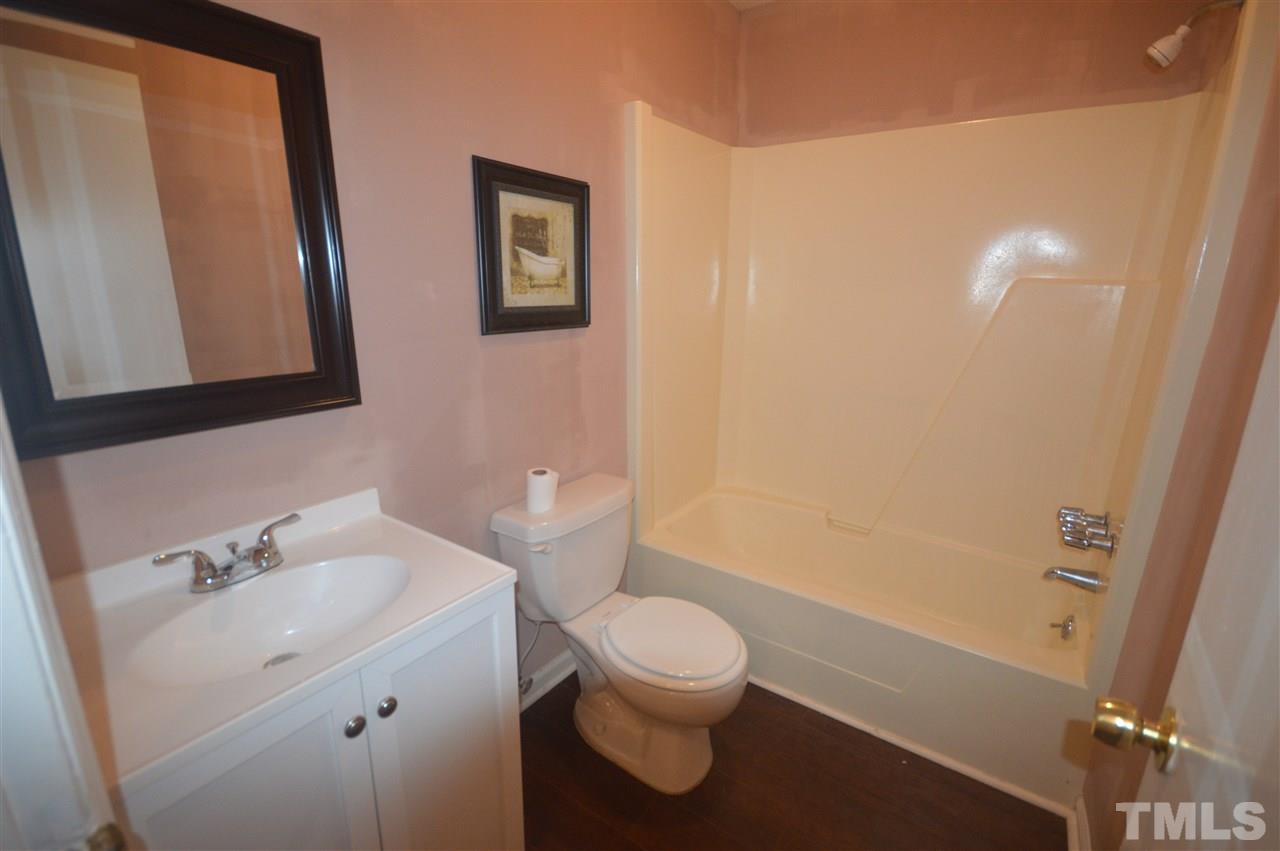 329 Clinton Carlyle Road Zebulon, NC 27597 - Photo 12 of 24 a bathroom with a sink a toilet and shower