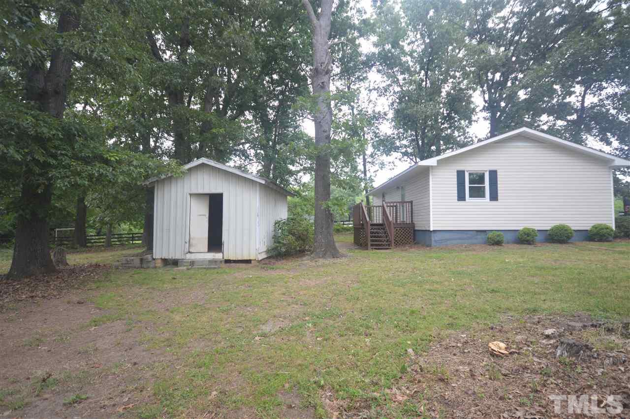 329 Clinton Carlyle Road Zebulon, NC 27597 - Photo 13 of 24 a house with trees in the background