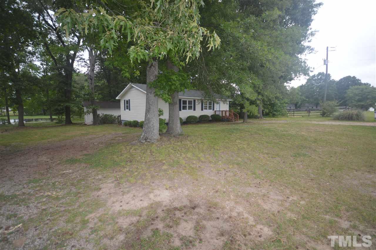 329 Clinton Carlyle Road Zebulon, NC 27597 - Photo 14 of 24 a view of a house with a yard and large trees