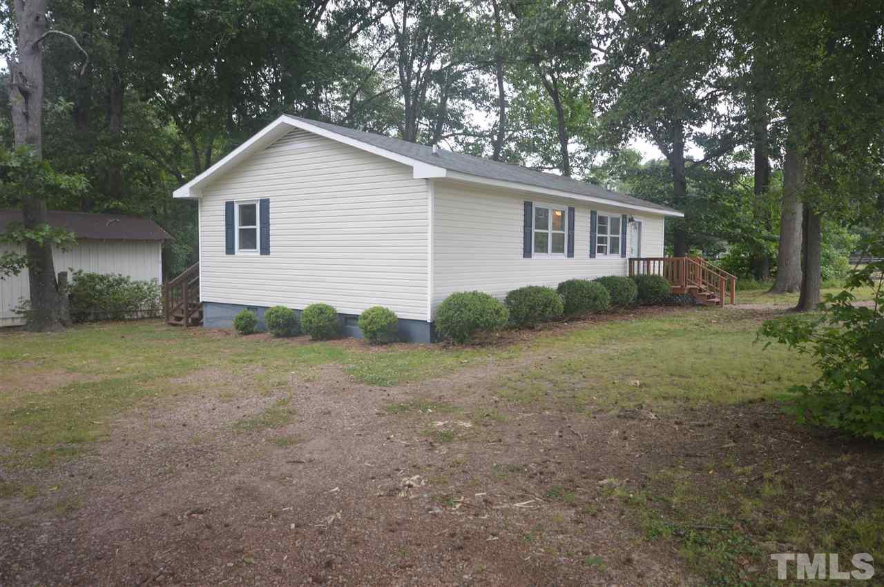 329 Clinton Carlyle Road Zebulon, NC 27597 - Photo 15 of 24 a view of a backyard with large trees