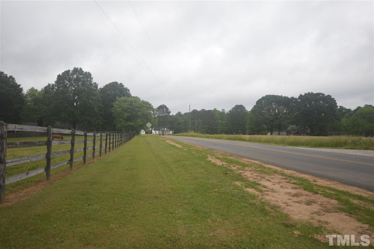 329 Clinton Carlyle Road Zebulon, NC 27597 - Photo 17 of 24 a view of a terrace with a yard