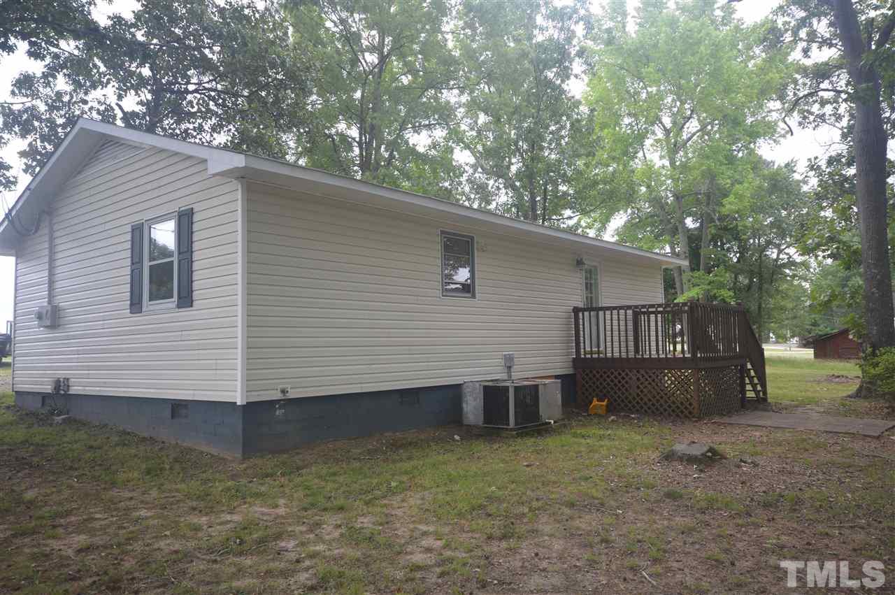 329 Clinton Carlyle Road Zebulon, NC 27597 - Photo 22 of 24 a view of a house with a yard and wooden fence
