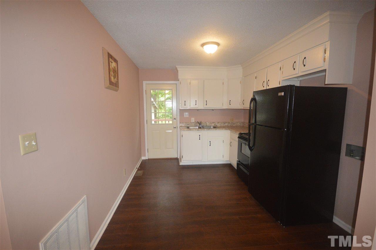 329 Clinton Carlyle Road Zebulon, NC 27597 - Photo 6 of 24 a kitchen with a refrigerator and a stove