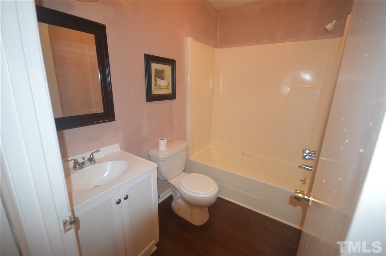 329 Clinton Carlyle Road Zebulon, NC 27597 - Photo 10 of 24 a bathroom with a sink a toilet and mirror