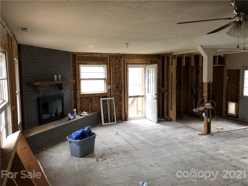 1420 Riverside Drive Charlotte, NC 28214 - Photo 9 of 13 a living room with furniture a window and a fireplace