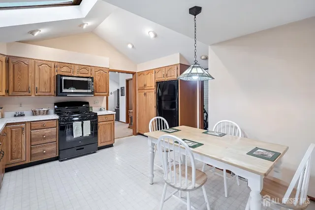 a kitchen with stainless steel appliances granite countertop a stove refrigerator and a microwave
