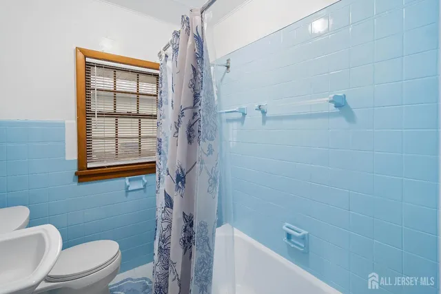 a bathroom with a toilet and shower