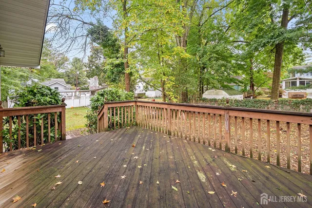 a view of balcony with wooden floor and fence